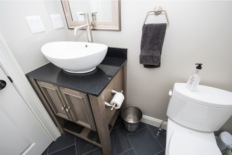 Small elegant 3/4 black tile and slate tile slate floor bathroom photo in Providence with furniture-like cabinets, distressed cabinets, a two-piece toilet, gray walls, a vessel sink and granite countertops
