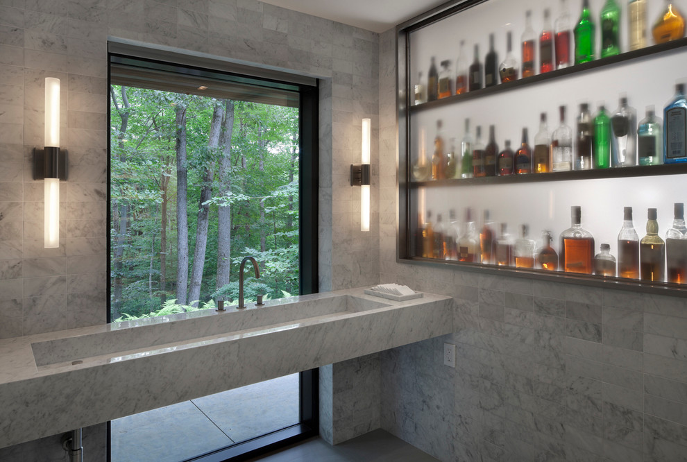 Example of a large minimalist master gray tile and ceramic tile dark wood floor bathroom design in New York with open cabinets, white walls, a wall-mount sink and marble countertops