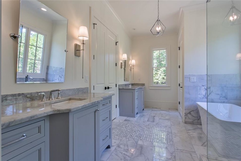 Bathroom - large transitional master gray tile and marble tile marble floor and gray floor bathroom idea in Atlanta with recessed-panel cabinets, gray cabinets, a two-piece toilet, white walls, an undermount sink, marble countertops, a hinged shower door and gray countertops
