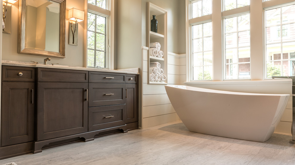 Inspiration för amerikanska en-suite badrum, med skåp i shakerstil, bruna skåp, ett fristående badkar, marmorkakel, grå väggar, marmorgolv, ett undermonterad handfat, marmorbänkskiva och vitt golv