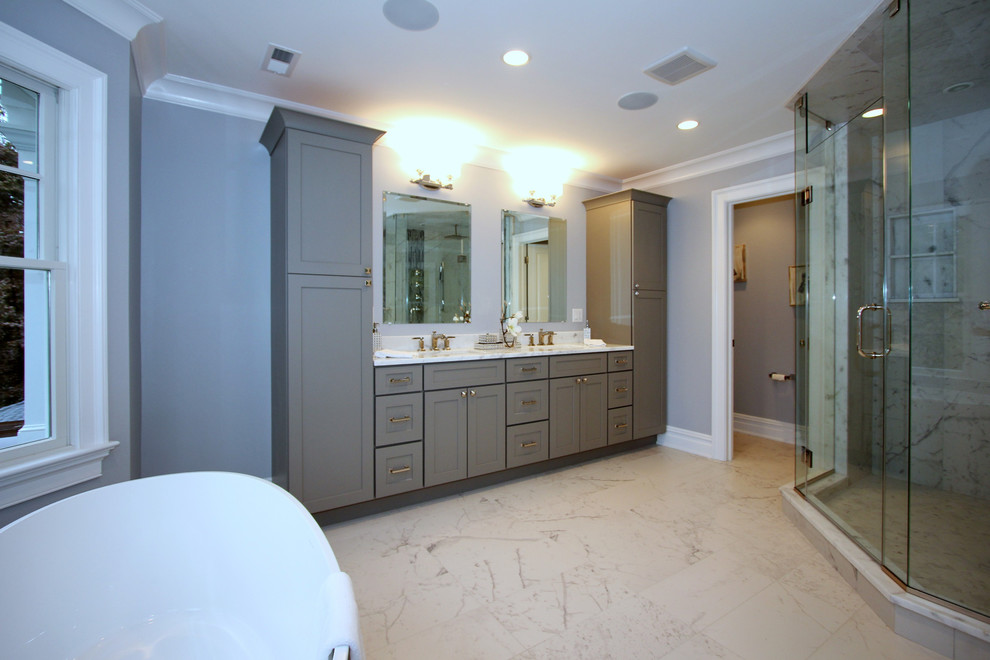 Inspiration for a large transitional master black tile, blue tile, gray tile and matchstick tile marble floor bathroom remodel in New York with shaker cabinets, gray cabinets, a two-piece toilet, gray walls, an undermount sink and marble countertops