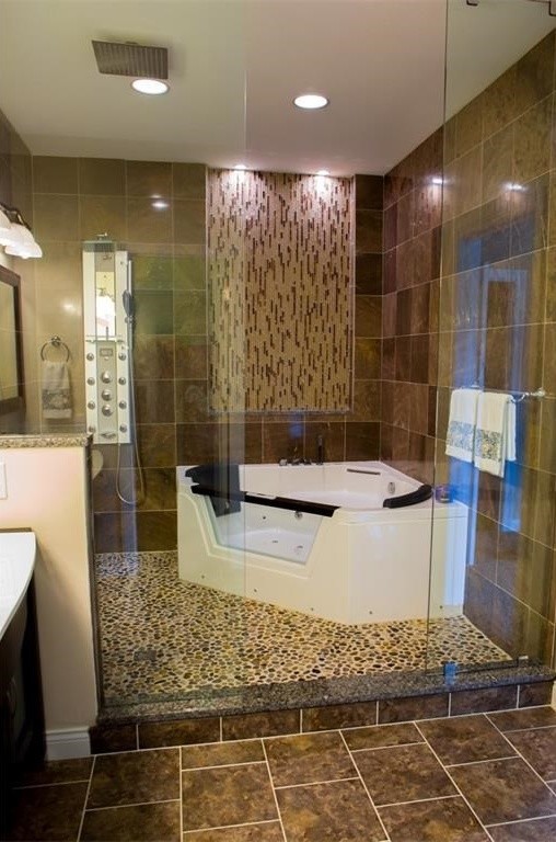 Example of a mid-sized trendy master brown tile and stone tile ceramic tile doorless shower design in Indianapolis with furniture-like cabinets, dark wood cabinets, a hot tub, a wall-mount toilet, beige walls, an integrated sink and granite countertops