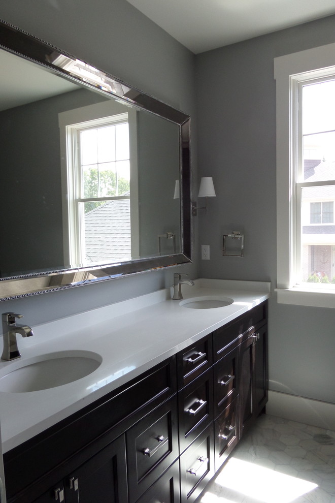 Inspiration for a large transitional kids' gray tile and stone tile marble floor bathroom remodel in Detroit with recessed-panel cabinets, dark wood cabinets, quartz countertops, an undermount sink and gray walls