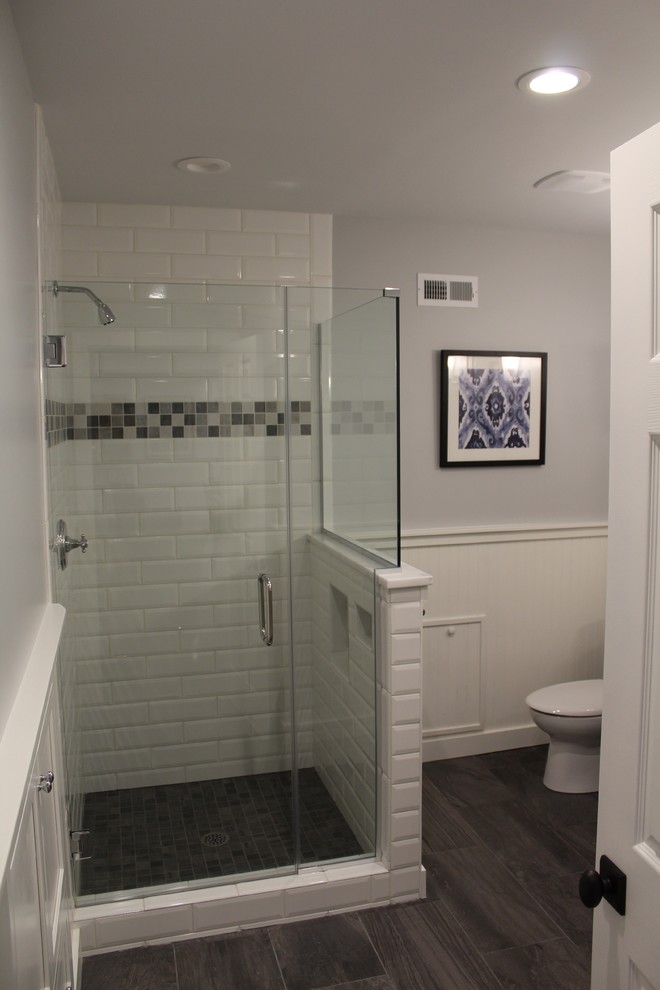Mid-sized trendy white tile and porcelain tile porcelain tile corner shower photo in Raleigh with shaker cabinets, gray cabinets, a one-piece toilet, gray walls and marble countertops