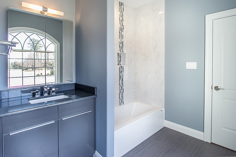 Mid-sized minimalist kids' white tile and ceramic tile ceramic tile and gray floor corner shower photo in Richmond with flat-panel cabinets, gray cabinets, a one-piece toilet, blue walls, an undermount sink and granite countertops