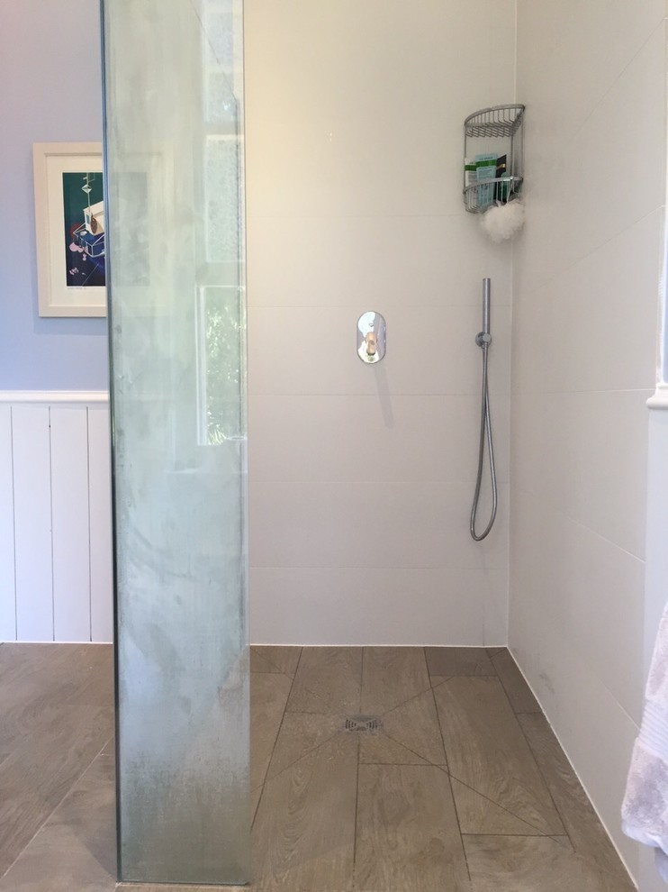 This is an example of a small victorian ensuite bathroom in Surrey with a walk-in shower, white tiles, cement tiles, blue walls, porcelain flooring and a pedestal sink.