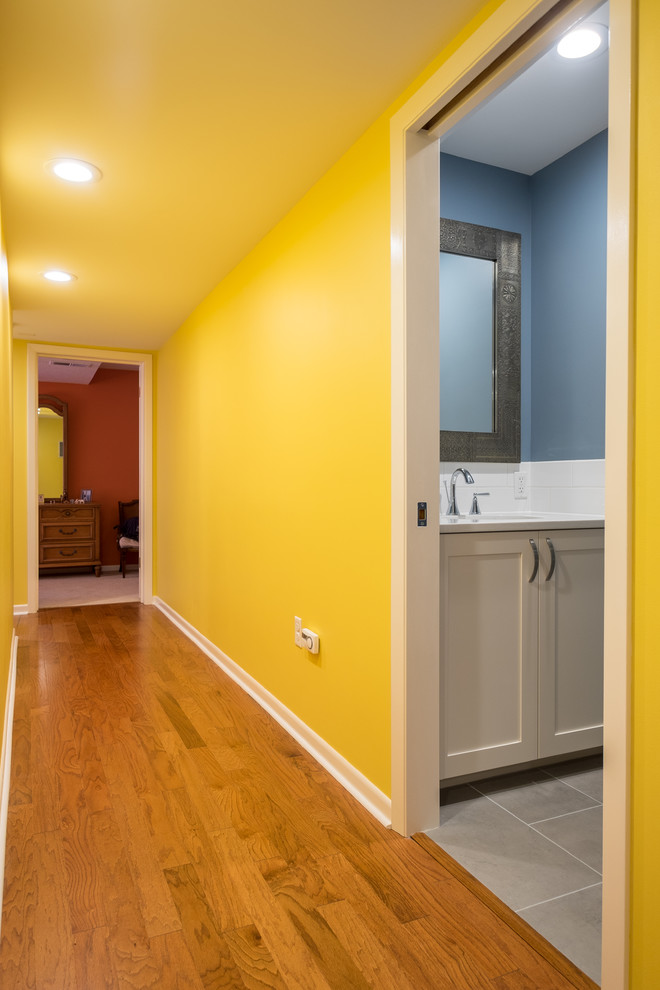 Mid-sized elegant master white tile and ceramic tile porcelain tile bathroom photo in Portland with recessed-panel cabinets, white cabinets, a two-piece toilet, blue walls, an undermount sink and quartz countertops