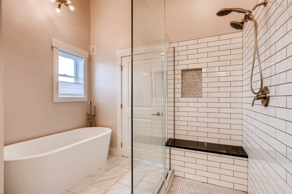 デンバーにあるおしゃれなマスターバスルーム (置き型浴槽、白いタイル、サブウェイタイル、グレーの壁、磁器タイルの床、マルチカラーの床) の写真