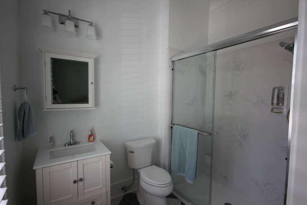 Design ideas for a medium sized classic shower room bathroom in Atlanta with shaker cabinets, white cabinets, a corner shower, a two-piece toilet, white tiles, porcelain tiles, white walls, marble flooring, a submerged sink, engineered stone worktops, multi-coloured floors and a hinged door.
