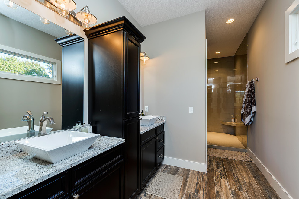 Design ideas for a medium sized classic ensuite bathroom in Chicago with an alcove shower, glass tiles, grey walls, dark hardwood flooring, a vessel sink, brown floors, multi-coloured worktops, recessed-panel cabinets, black cabinets and an open shower.
