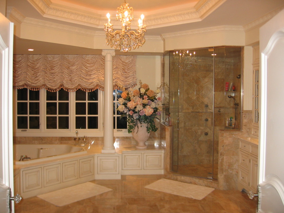 Example of a large tuscan master beige tile, brown tile and ceramic tile porcelain tile bathroom design in New York with raised-panel cabinets, beige cabinets, a one-piece toilet and beige walls