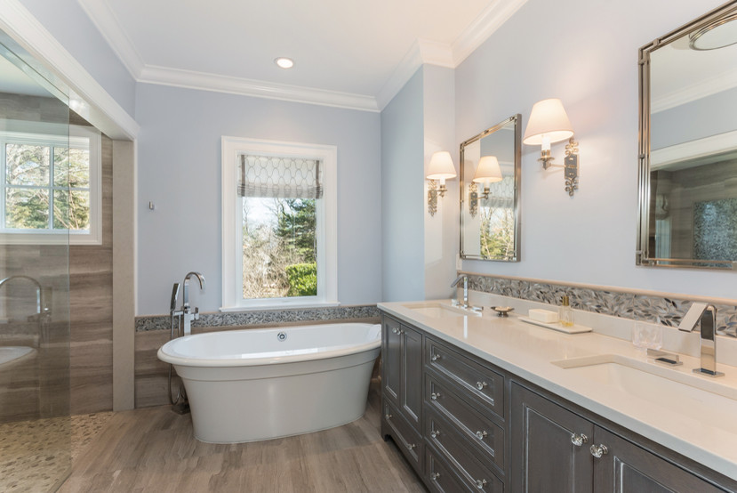 Inspiration for a mid-sized transitional master multicolored tile and stone tile medium tone wood floor and green floor bathroom remodel in New York with shaker cabinets, gray cabinets, a two-piece toilet, blue walls, an undermount sink and marble countertops