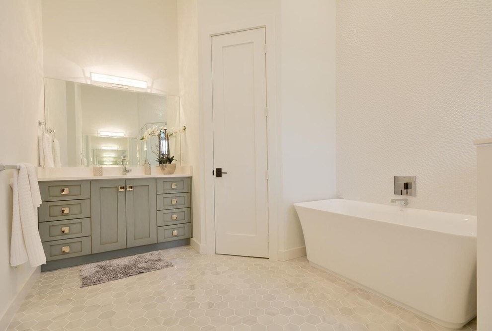 Inspiration for a contemporary master white tile ceramic tile and beige floor freestanding bathtub remodel in Miami with a one-piece toilet, white walls, an undermount sink, solid surface countertops, shaker cabinets and green cabinets