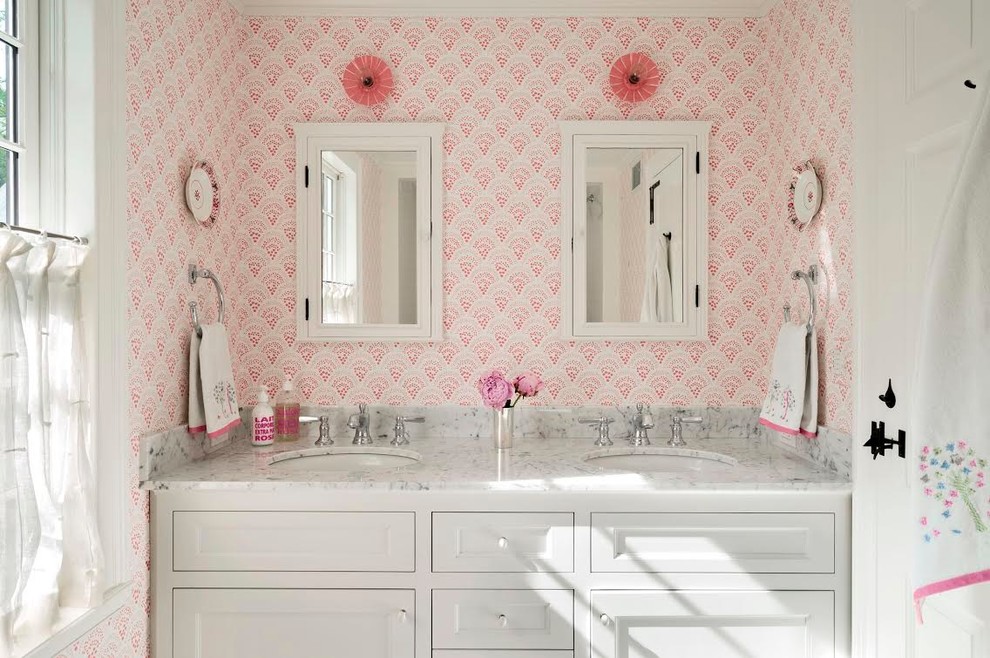 Alcove shower - large traditional ceramic tile alcove shower idea in Boston with recessed-panel cabinets, white cabinets, a drop-in sink, marble countertops and pink walls