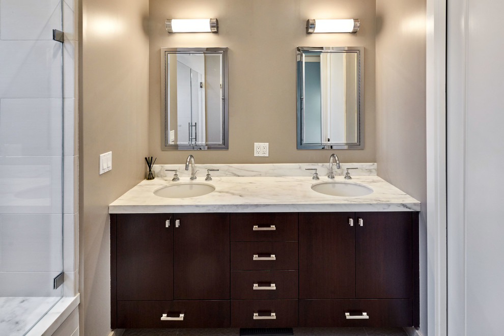 Medium sized traditional ensuite bathroom in San Francisco with shaker cabinets, black cabinets, an alcove shower, a one-piece toilet, white tiles, mirror tiles, beige walls, ceramic flooring, a submerged sink, marble worktops, beige floors and a hinged door.