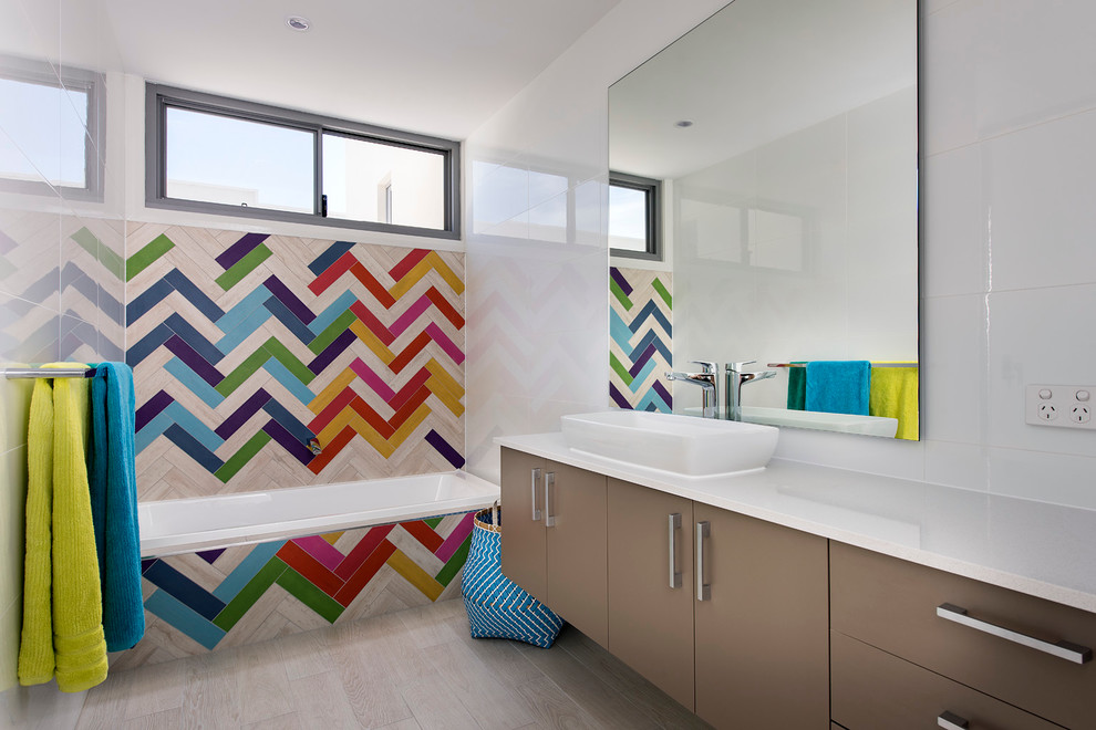 Inspiration for a large contemporary kids' multicolored tile and ceramic tile ceramic tile alcove bathtub remodel in Perth with brown cabinets, solid surface countertops, white walls and flat-panel cabinets
