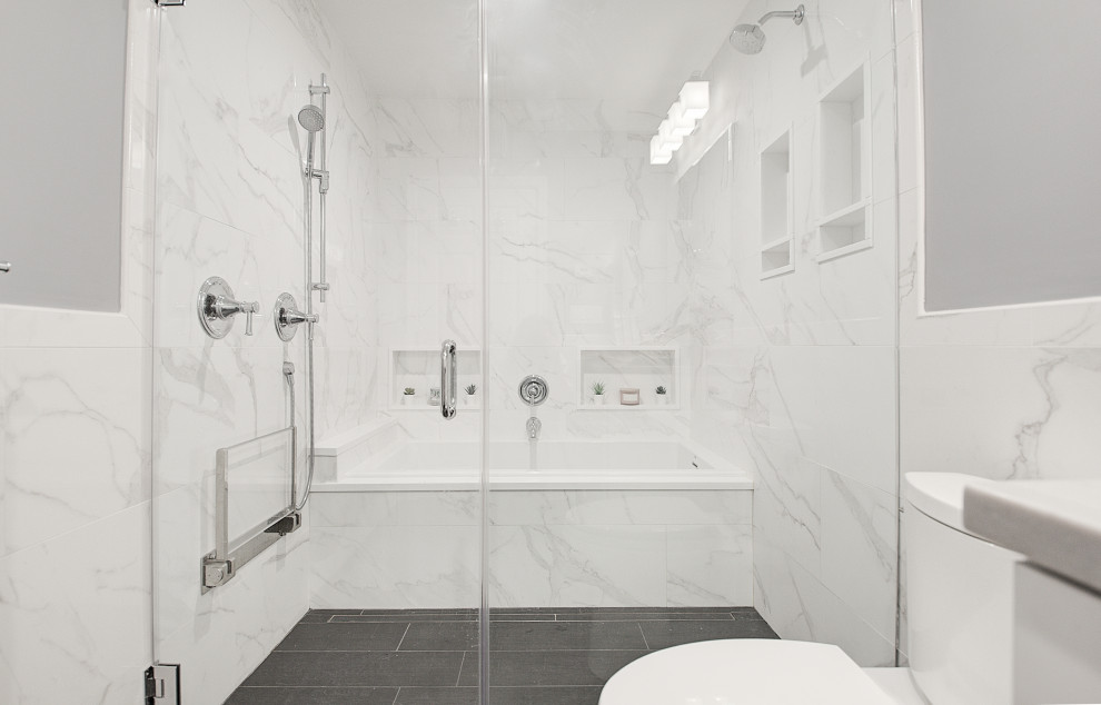 Photo of a medium sized classic bathroom in Other with recessed-panel cabinets, white cabinets, a built-in bath, a walk-in shower, a two-piece toilet, white tiles, porcelain tiles, grey walls, porcelain flooring, a submerged sink, engineered stone worktops, grey floors, a hinged door, grey worktops, a shower bench, a single sink and a built in vanity unit.