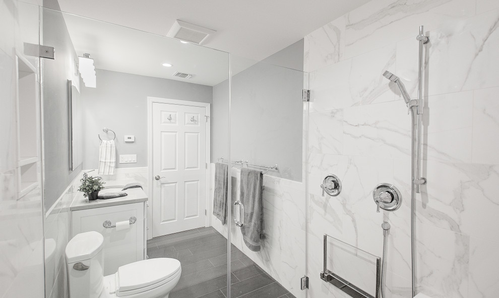 Example of a mid-sized transitional white tile and porcelain tile porcelain tile, gray floor and single-sink bathroom design in Other with recessed-panel cabinets, white cabinets, a two-piece toilet, gray walls, an undermount sink, quartz countertops, a hinged shower door, gray countertops and a built-in vanity