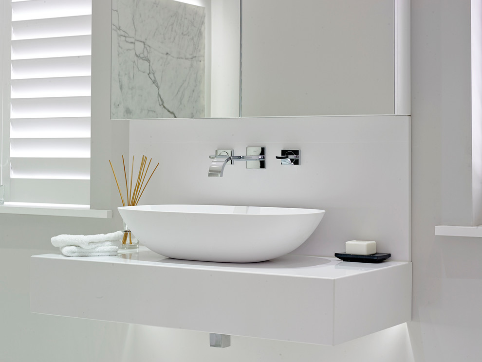 Inspiration for a large contemporary master bathroom remodel in London with white walls, a vessel sink, solid surface countertops and white countertops