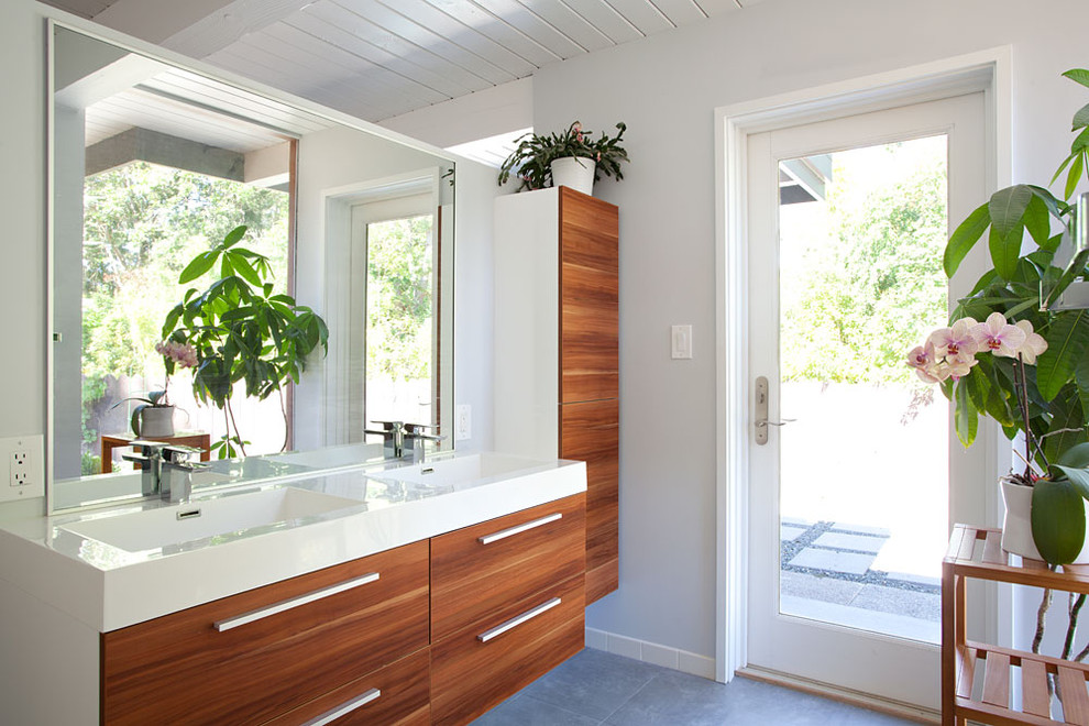 This is an example of a midcentury bathroom in San Francisco with an integrated sink.