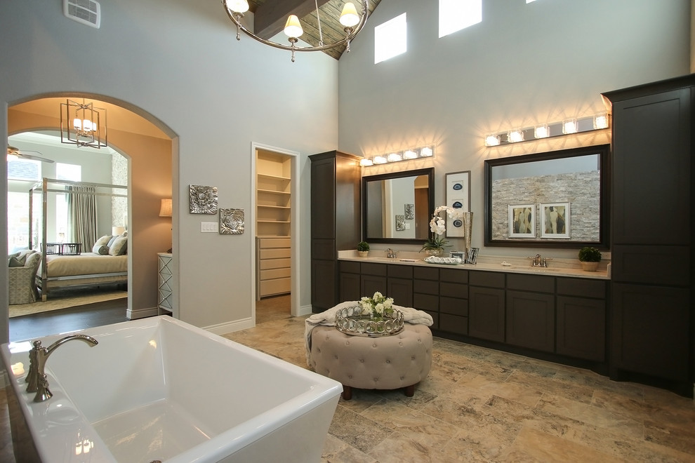 Example of a huge classic master beige tile and stone tile travertine floor bathroom design in Houston with raised-panel cabinets, dark wood cabinets, a one-piece toilet, gray walls, a drop-in sink and marble countertops