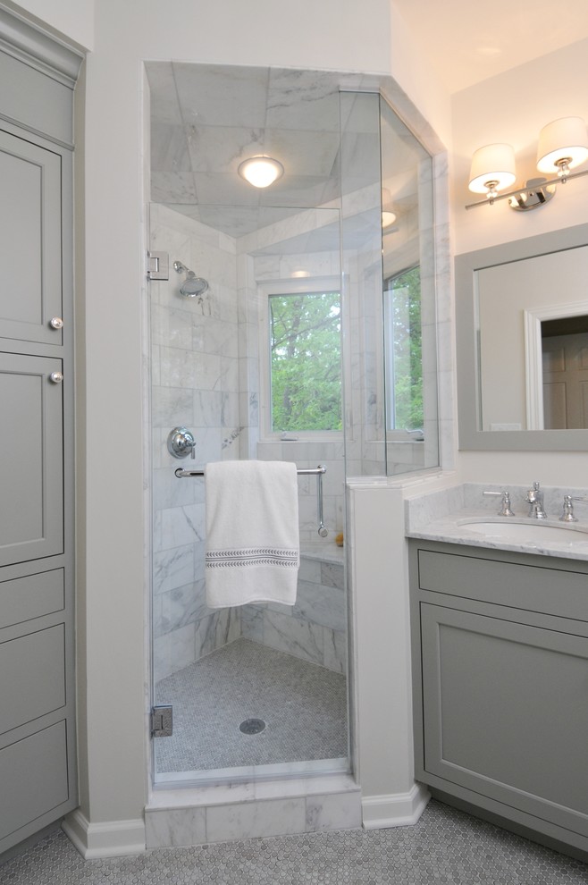 Corner shower - mid-sized traditional master gray tile and stone tile ceramic tile corner shower idea in Chicago with gray cabinets, shaker cabinets, a two-piece toilet, white walls, marble countertops and an undermount sink