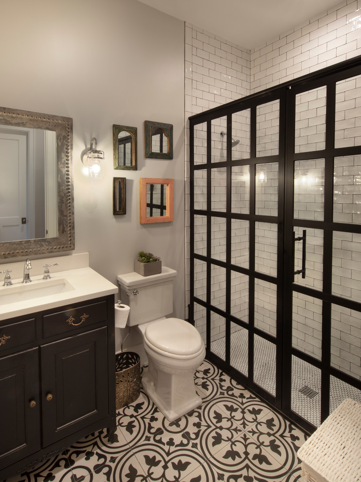 Photo of a medium sized classic family bathroom in Miami with shaker cabinets, brown cabinets, an alcove bath, an alcove shower, white tiles, grey walls, medium hardwood flooring, a built-in sink, white floors, a hinged door and white worktops.