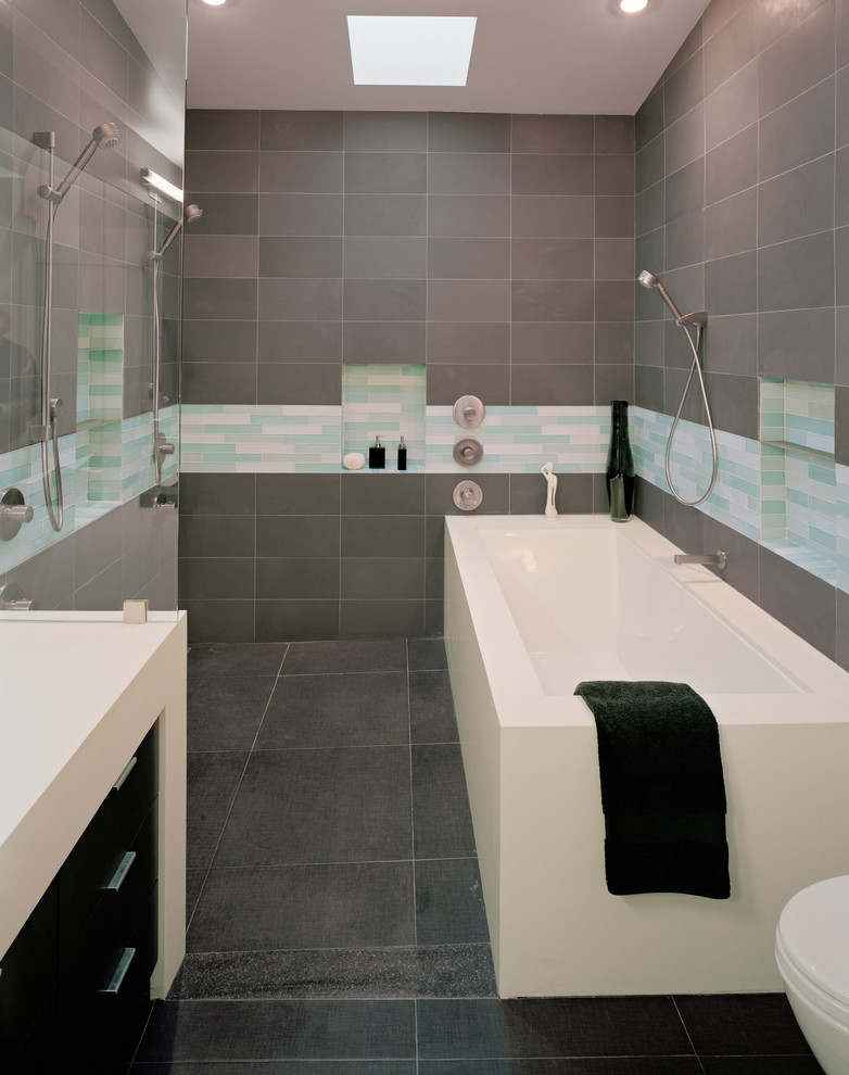 Bathroom - huge modern master gray tile and porcelain tile porcelain tile and gray floor bathroom idea in San Francisco with a drop-in sink, flat-panel cabinets, dark wood cabinets, solid surface countertops, an undermount tub, a wall-mount toilet, gray walls and white countertops