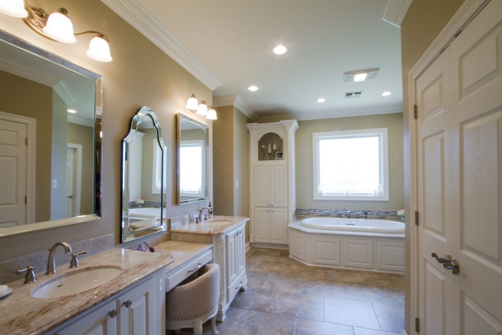 Example of a mid-sized classic master beige tile and ceramic tile travertine floor and brown floor bathroom design in New Orleans with recessed-panel cabinets, white cabinets, a two-piece toilet, beige walls, an undermount sink, marble countertops and a hinged shower door