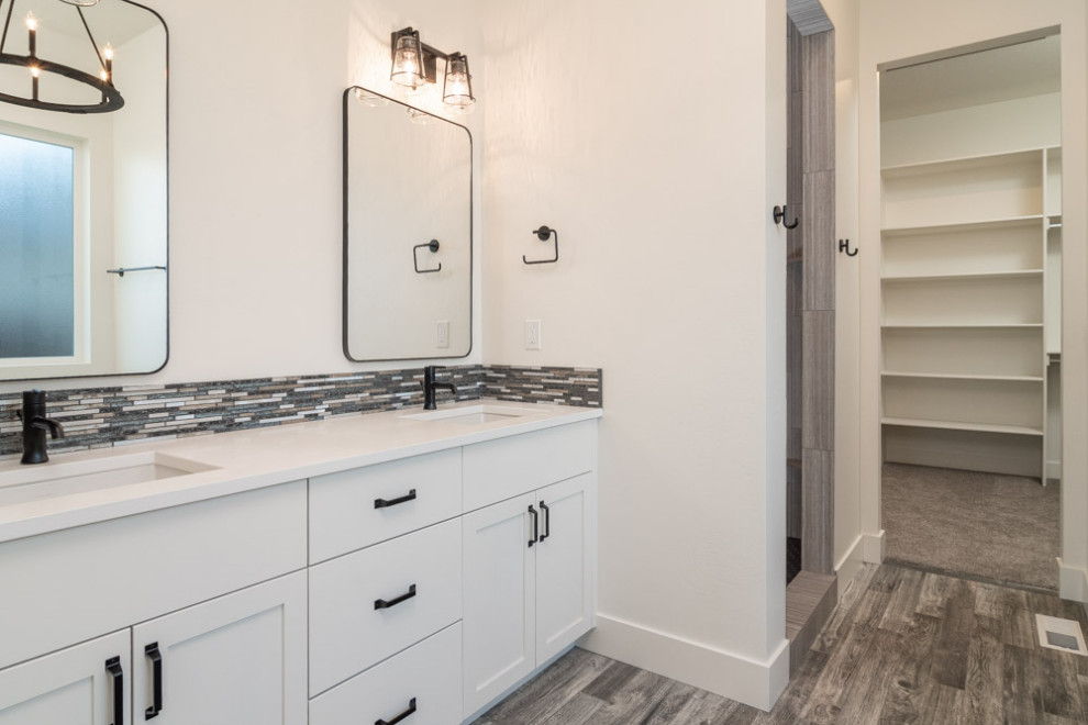 Mid-sized cottage master multicolored tile and matchstick tile dark wood floor and gray floor alcove shower photo in Boise with shaker cabinets, white cabinets, white walls, an undermount sink, quartz countertops and white countertops