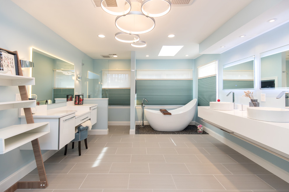 Идея дизайна: главная ванная комната среднего размера в современном стиле с плоскими фасадами, белыми фасадами, отдельно стоящей ванной, угловым душем, синими стенами, консольной раковиной, серым полом, открытым душем, полом из керамогранита, столешницей из искусственного камня и зеркалом с подсветкой