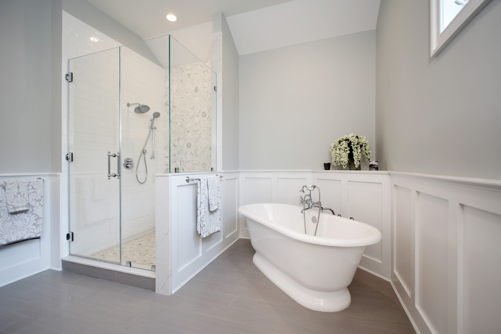 Medium sized classic ensuite bathroom in New York with a freestanding bath, an alcove shower, white tiles, porcelain tiles, grey walls, porcelain flooring, grey floors and a hinged door.