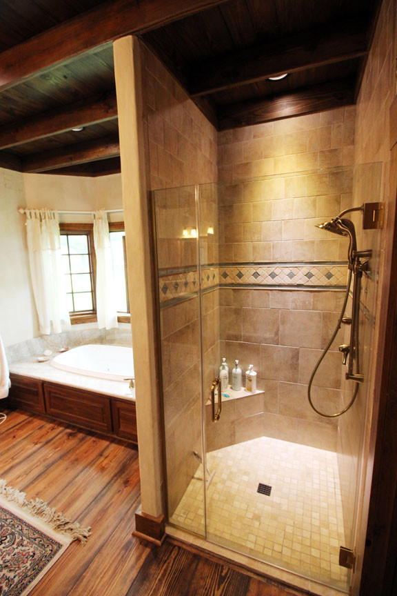 Photo of a large rural ensuite bathroom in Austin with dark wood cabinets, a built-in bath, an alcove shower, beige walls, dark hardwood flooring and a built-in sink.
