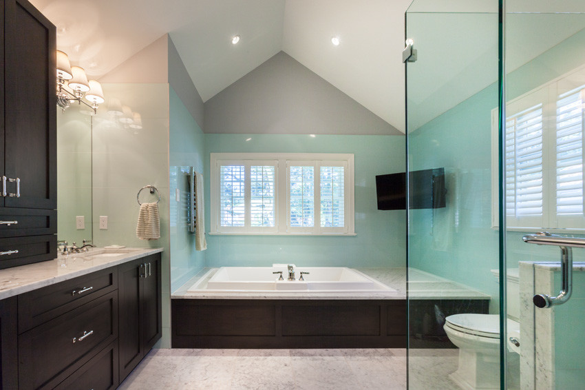 Bathroom - large contemporary master glass sheet marble floor and white floor bathroom idea in New York with recessed-panel cabinets, dark wood cabinets, a two-piece toilet, an undermount sink, marble countertops, a hinged shower door, blue walls and white countertops