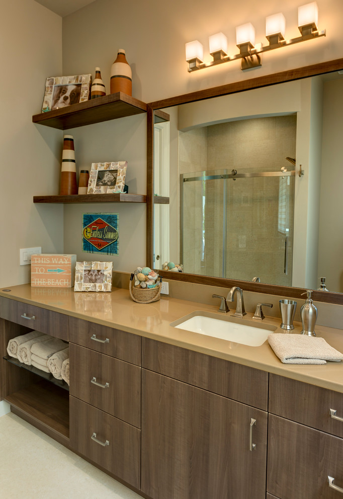 Photo of a classic bathroom in Orlando with a submerged sink, flat-panel cabinets, dark wood cabinets and beige walls.