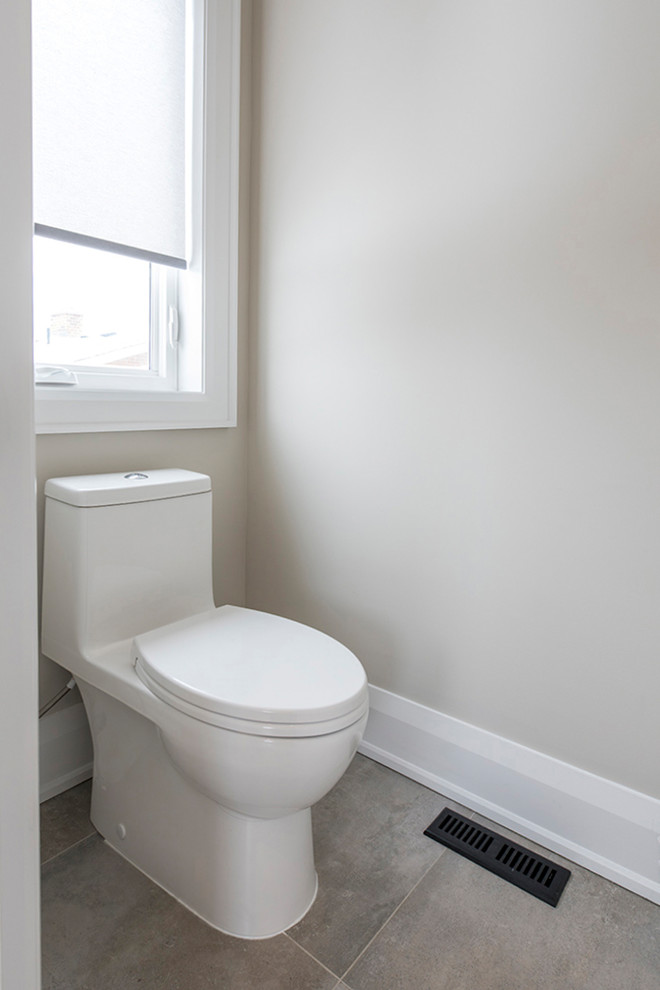 This is an example of a medium sized modern ensuite bathroom in Toronto with flat-panel cabinets, white cabinets, a freestanding bath, a corner shower, a one-piece toilet, beige walls, medium hardwood flooring, a submerged sink, engineered stone worktops and a hinged door.