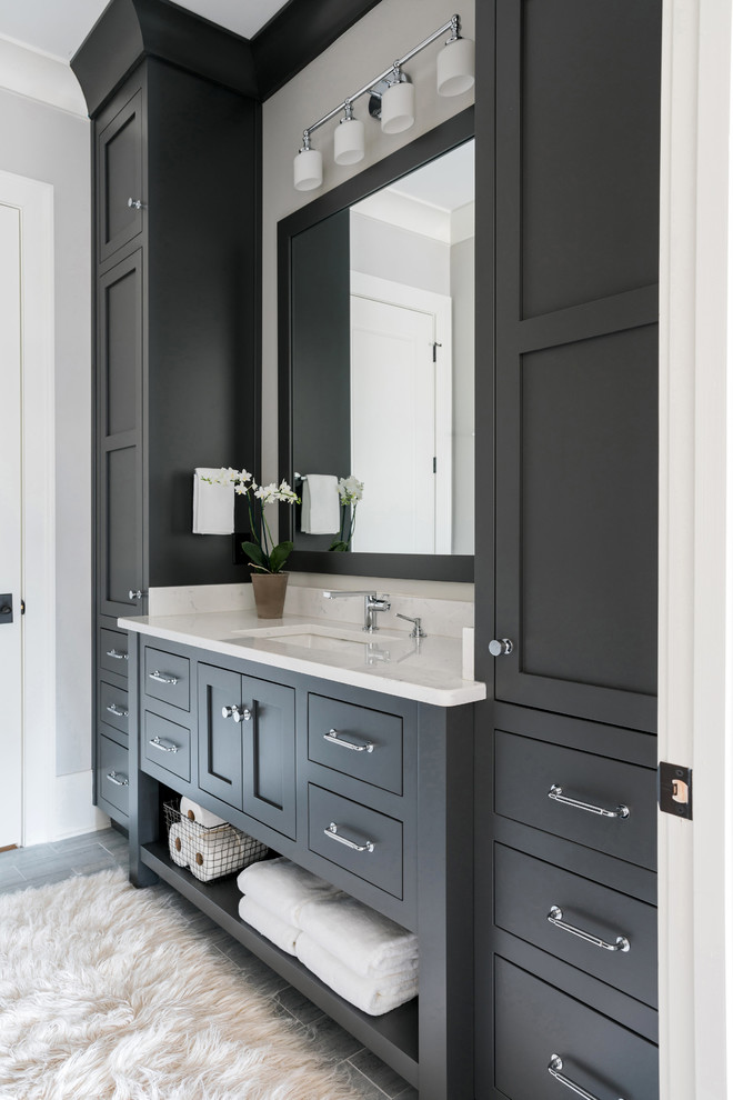 Inspiration for a mid-sized transitional master white tile and subway tile laminate floor and gray floor alcove shower remodel in Atlanta with shaker cabinets, gray walls, an undermount sink, quartz countertops, a hinged shower door and gray cabinets