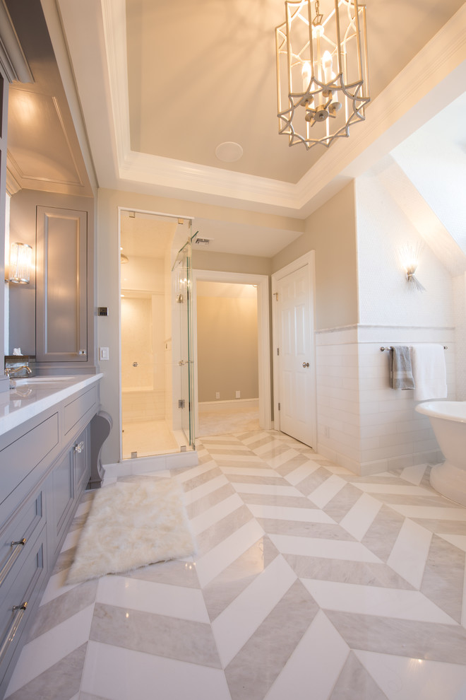 Large transitional master white tile and subway tile mosaic tile floor bathroom photo in New York with beaded inset cabinets, gray cabinets, gray walls, an undermount sink and quartz countertops
