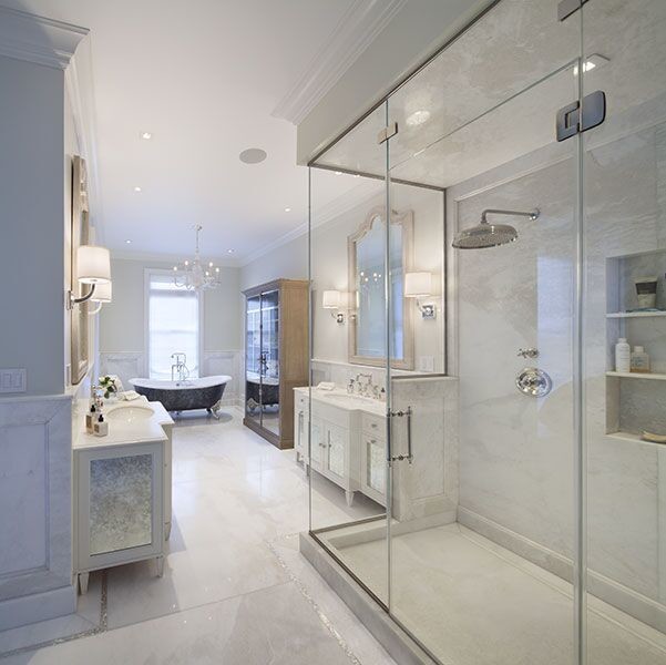 Example of a large classic master white tile and marble tile marble floor and white floor bathroom design in New York with furniture-like cabinets, white cabinets, gray walls, an undermount sink, solid surface countertops and a hinged shower door