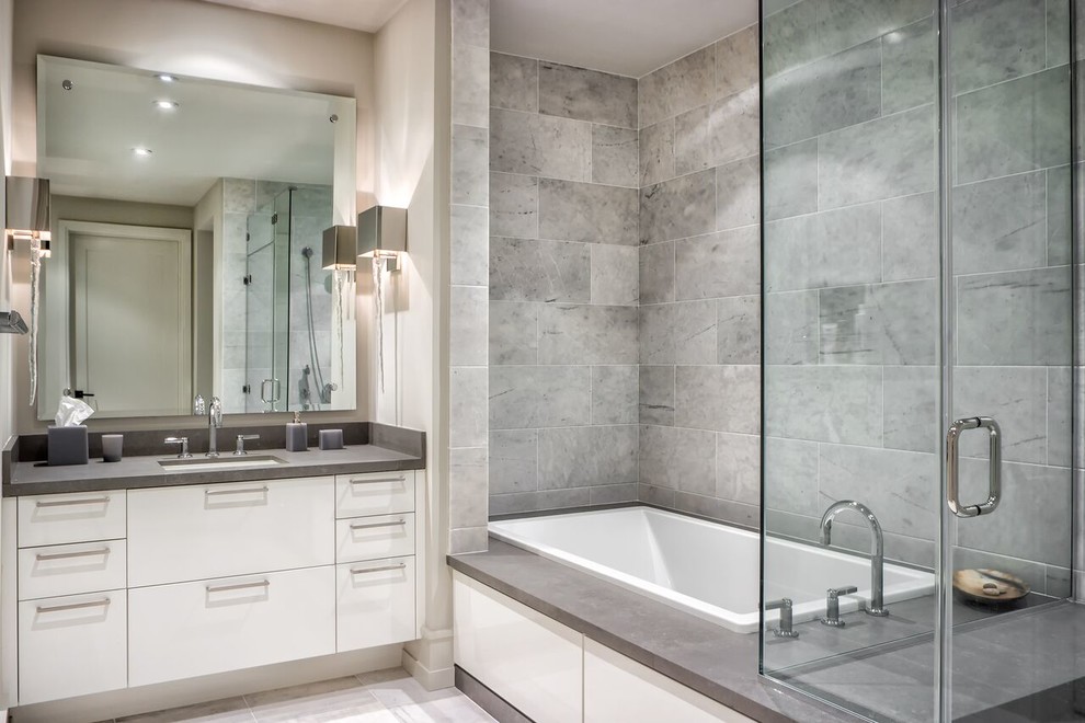 Inspiration for a small contemporary bathroom in Orange County with flat-panel cabinets, white cabinets, a built-in bath, a corner shower, a one-piece toilet, multi-coloured tiles, mosaic tiles, grey walls, a submerged sink and quartz worktops.