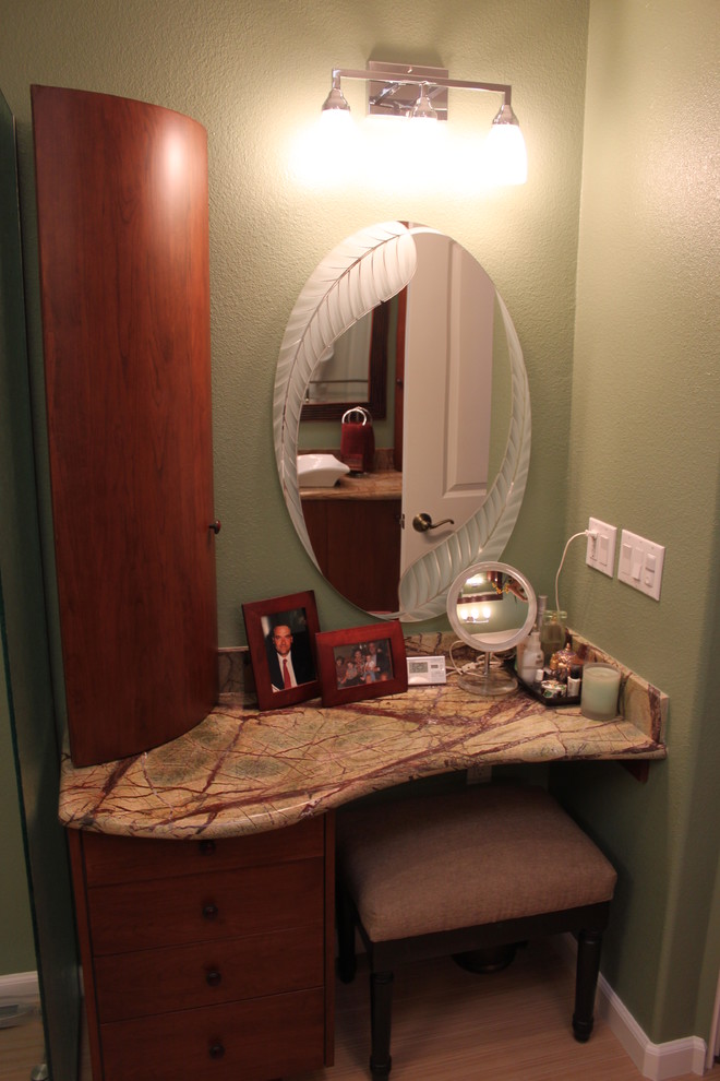 Exemple d'une douche en alcôve principale exotique en bois brun de taille moyenne avec une vasque, un placard à porte plane, un plan de toilette en marbre, une baignoire indépendante, WC séparés, un carrelage beige, des carreaux de porcelaine, un mur vert et un sol en carrelage de porcelaine.