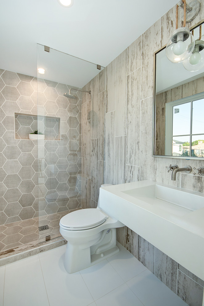 This is an example of a nautical shower room bathroom in Orange County with white cabinets, an alcove shower, a two-piece toilet, beige tiles, an integrated sink, white floors and white worktops.