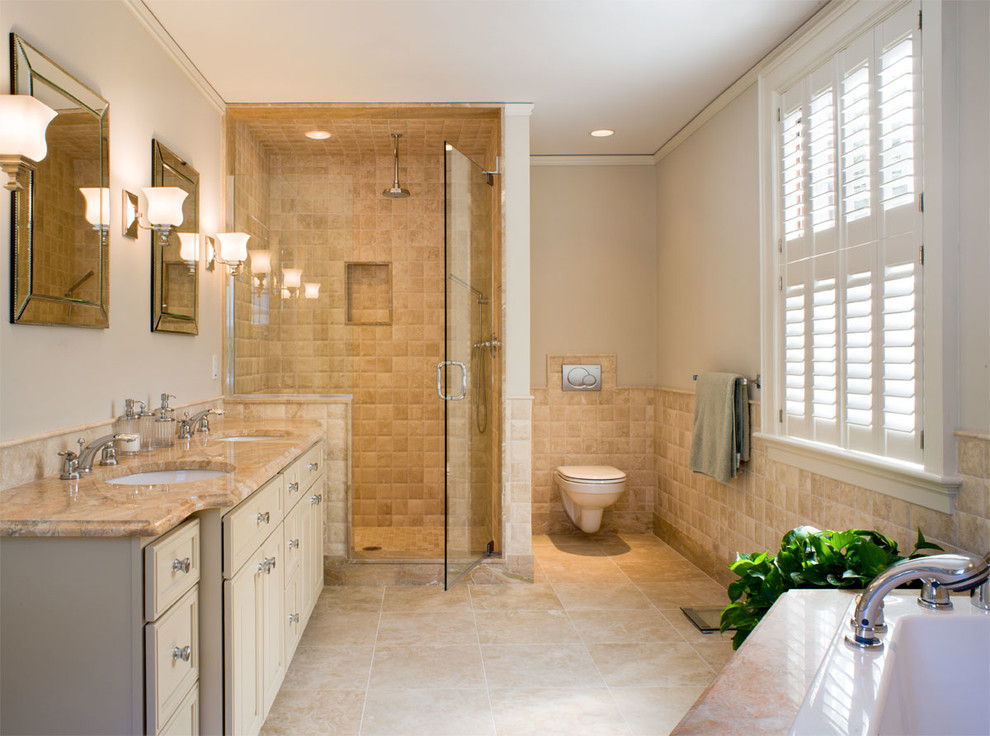Inspiration for a medium sized classic ensuite bathroom in Providence with a submerged sink, recessed-panel cabinets, beige cabinets, a built-in bath, an alcove shower, a wall mounted toilet, beige tiles, limestone tiles, beige walls, limestone flooring, limestone worktops, beige floors and a shower curtain.