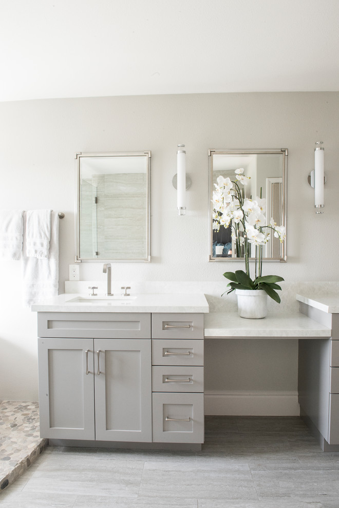 Photo of a medium sized traditional ensuite bathroom in Orange County with shaker cabinets, white cabinets, a freestanding bath, a one-piece toilet, grey walls, light hardwood flooring, grey floors, a sliding door and a submerged sink.