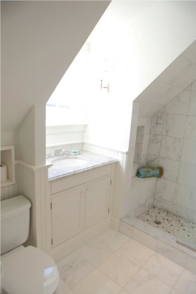 Example of a small classic master white tile and ceramic tile ceramic tile doorless shower design in Providence with flat-panel cabinets, white cabinets, a one-piece toilet, white walls, granite countertops and an undermount sink