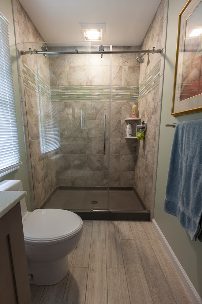 Example of a small trendy master gray tile and ceramic tile porcelain tile and gray floor bathroom design in New York with shaker cabinets, gray cabinets, a one-piece toilet, green walls, an undermount sink and onyx countertops