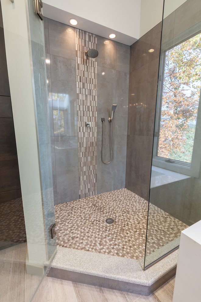 Inspiration for a large modern master gray tile and porcelain tile travertine floor and gray floor bathroom remodel in New York with flat-panel cabinets, brown cabinets, a two-piece toilet, gray walls, an undermount sink, recycled glass countertops and a hinged shower door