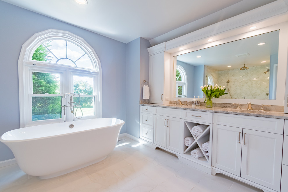 Inspiration for a medium sized classic ensuite bathroom in Philadelphia with white cabinets, a freestanding bath, porcelain tiles, quartz worktops, flat-panel cabinets, a double shower, a one-piece toilet, blue tiles, blue walls, porcelain flooring, a submerged sink, white floors and a hinged door.