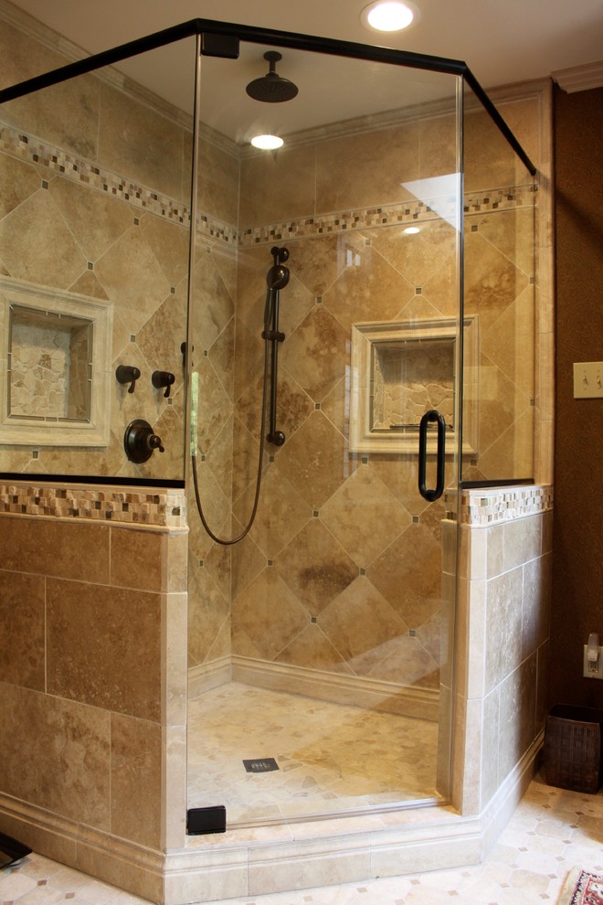 Inspiration for a medium sized traditional ensuite bathroom with raised-panel cabinets, dark wood cabinets, a corner shower, a two-piece toilet, beige tiles, stone tiles, brown walls, travertine flooring, a submerged sink and granite worktops.
