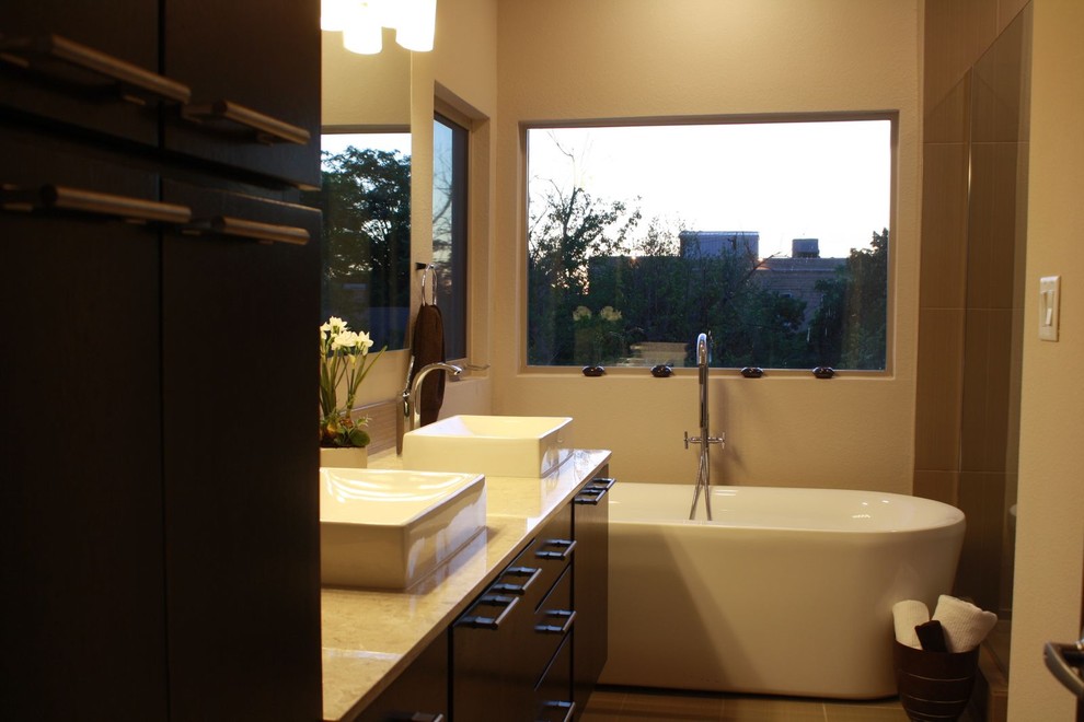 Example of a trendy freestanding bathtub design in Austin with a vessel sink